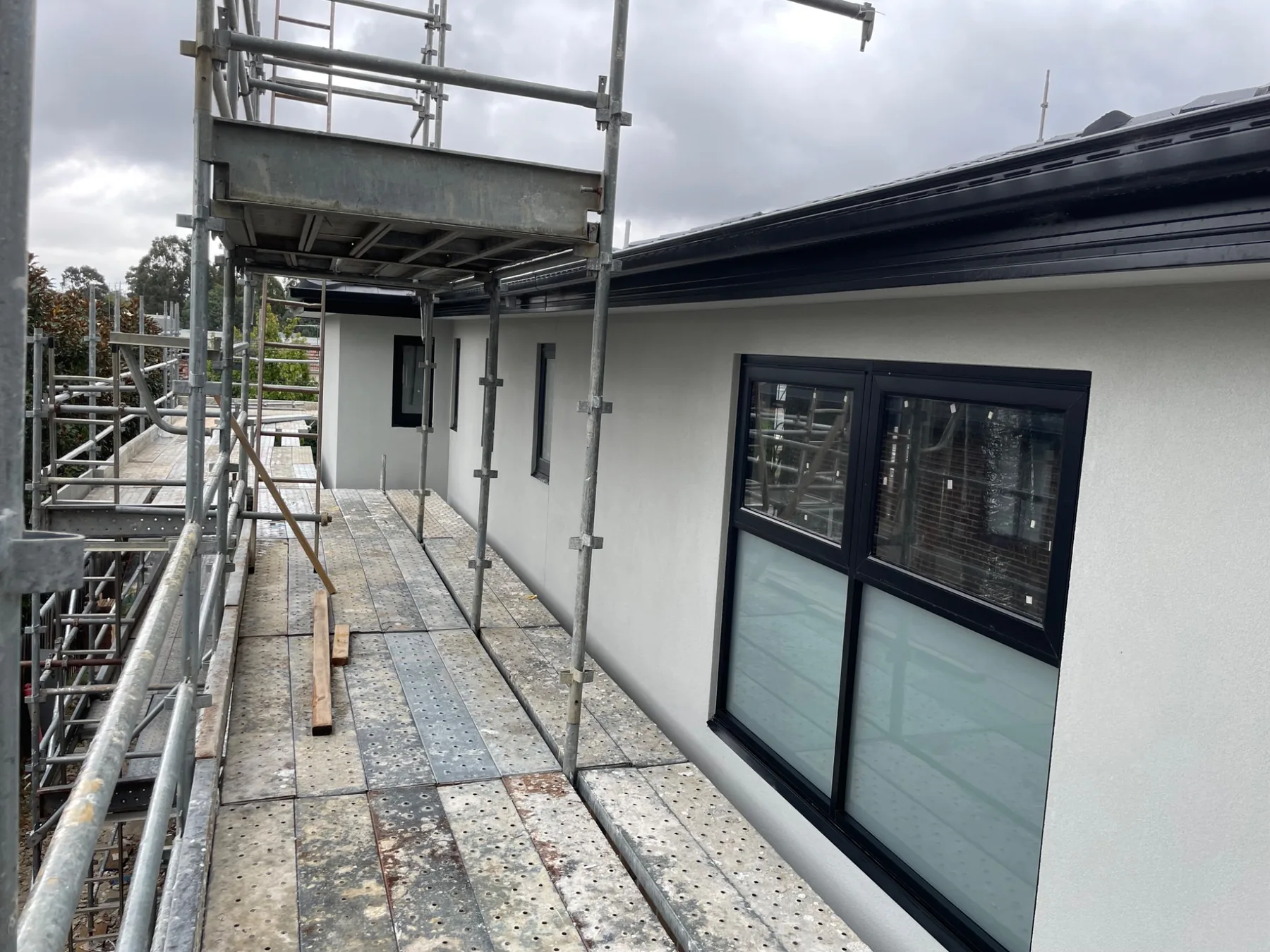 New build exterior facade with windows and scaffolding