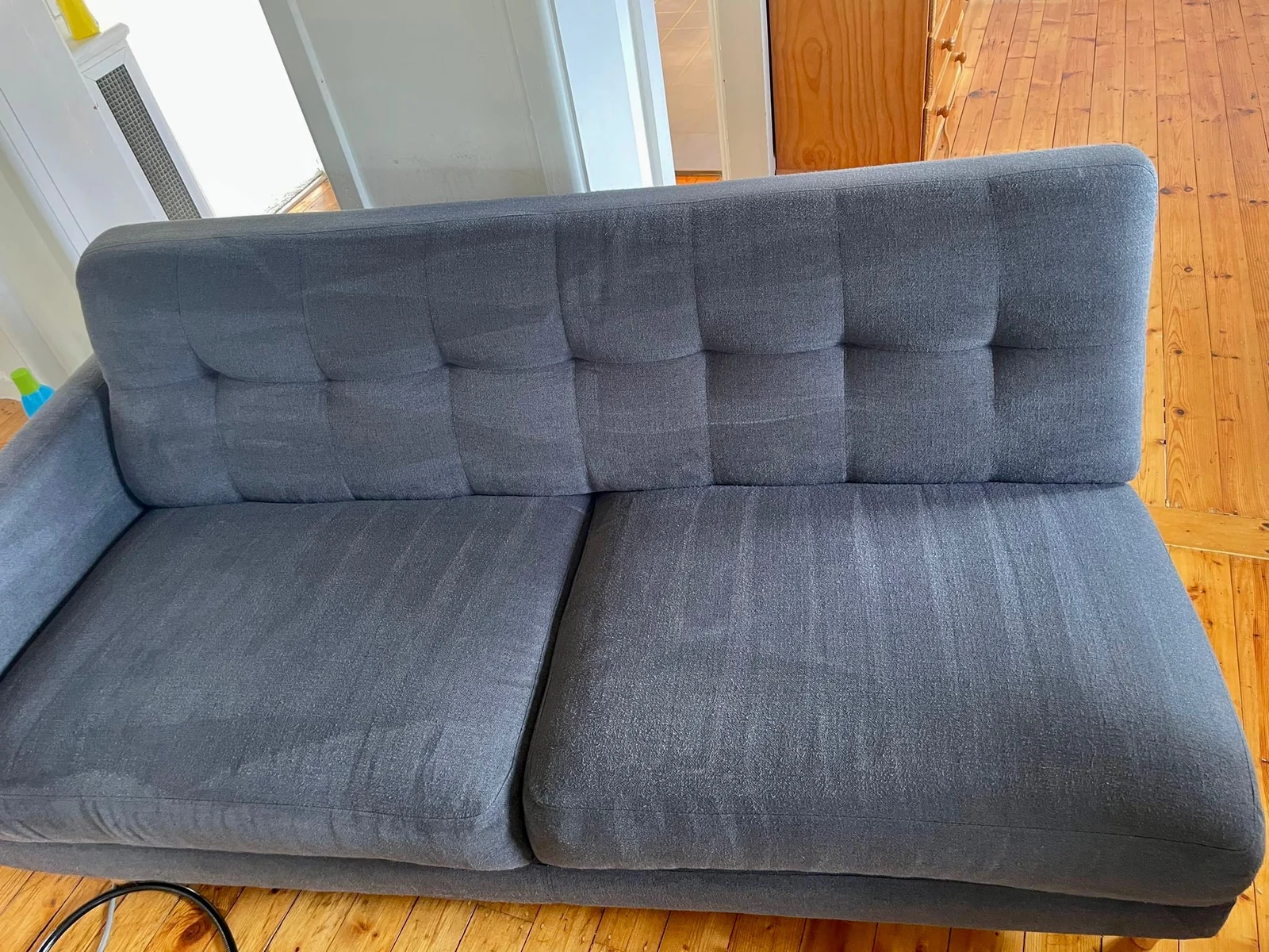 Freshly cleaned grey sofa by Domain Services CL