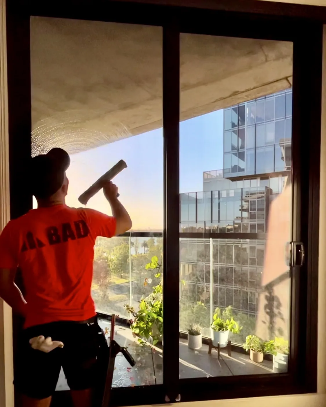 Window cleaning inside a Melbourne apartment